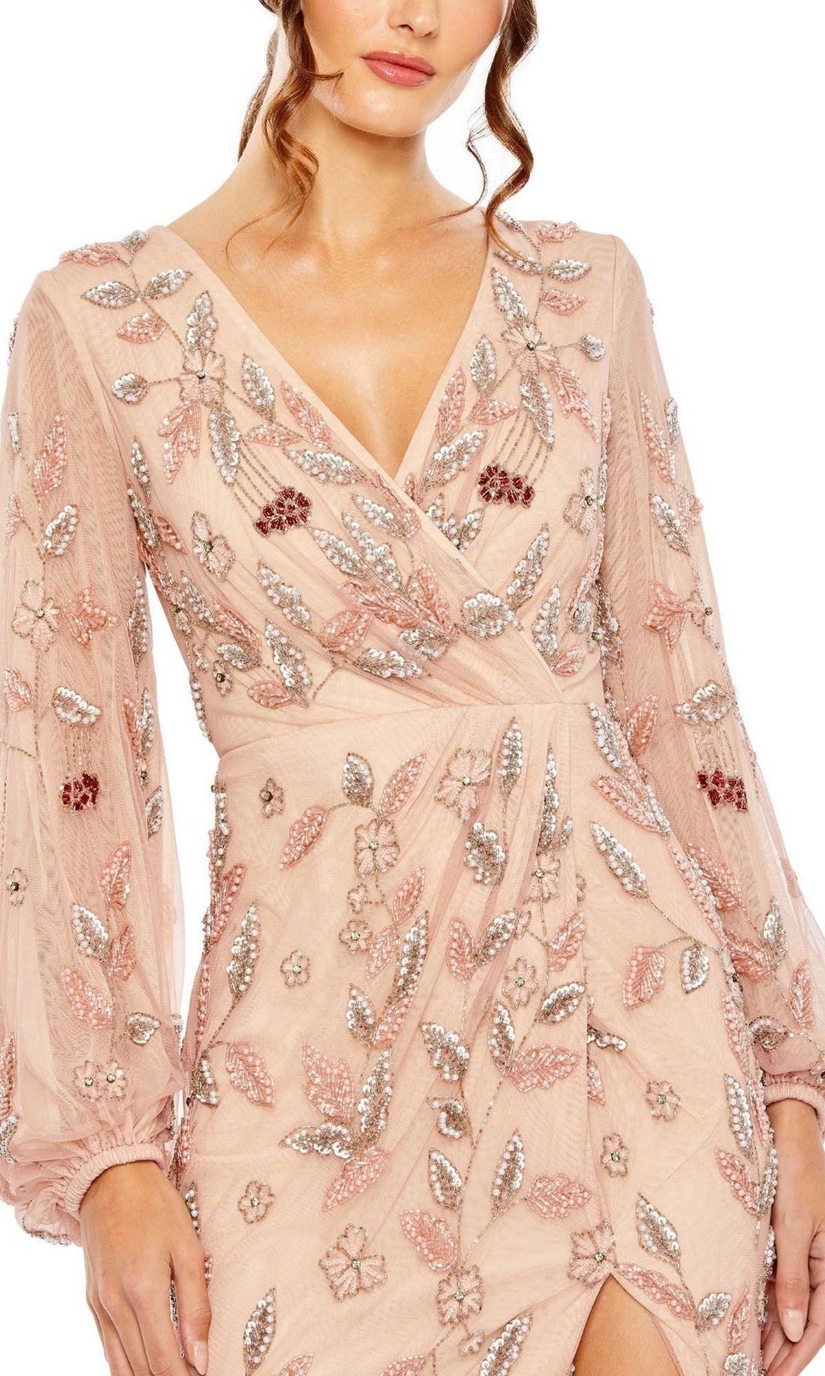 A woman wears the Rosewood Pink Beaded Formal Gown by Mac Duggal (style 93755), featuring long sheer sleeves and silver and pink sequin floral and leaf embellishments—an elegant mother of the bride dress.